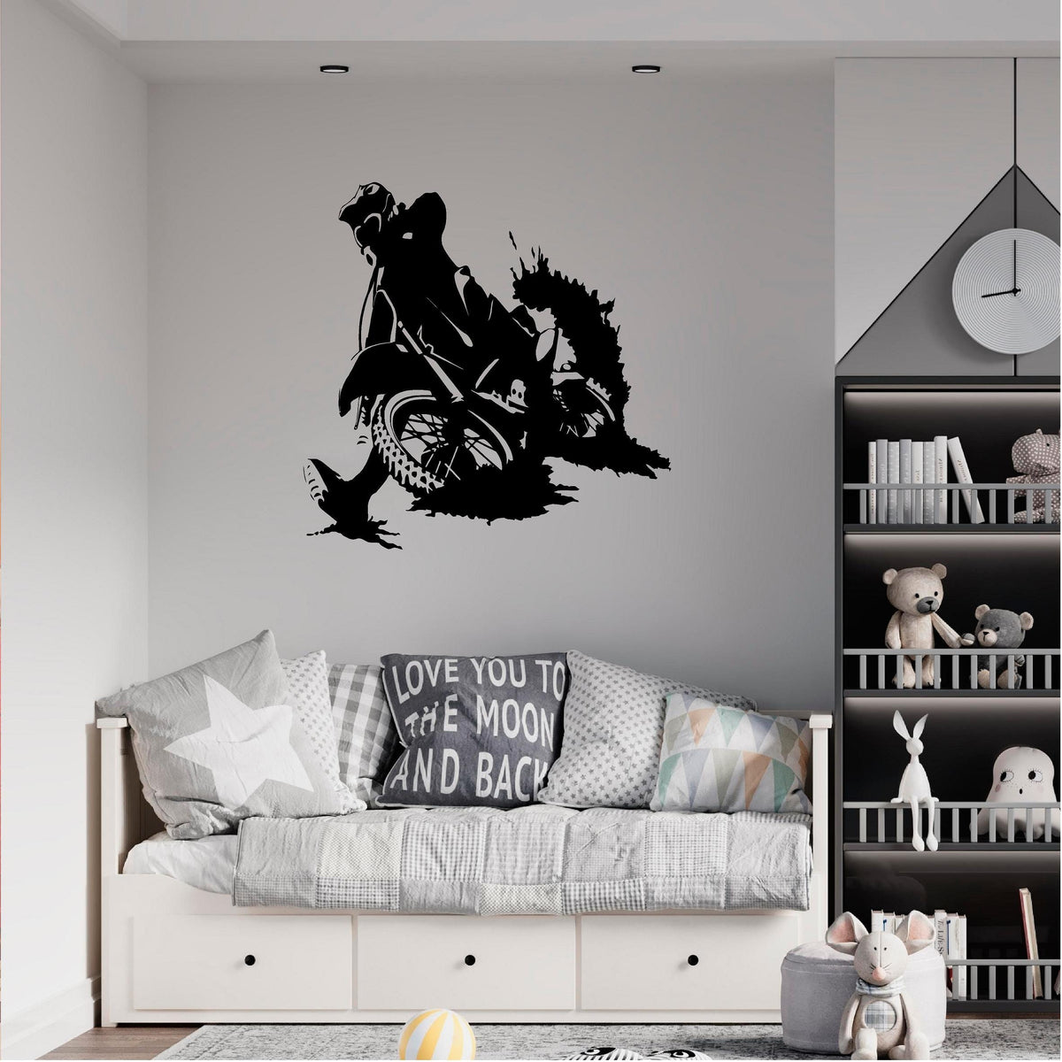 Black motocross rally rider wall decal above a child's daybed