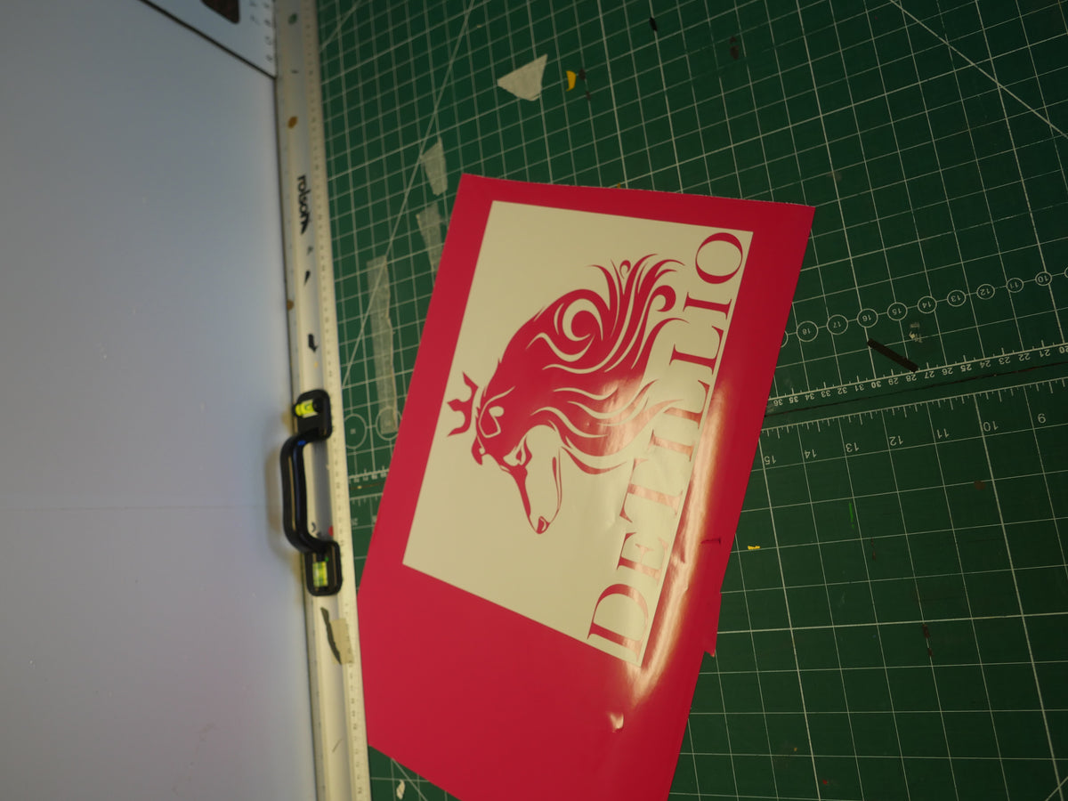 Crowned lion logo — prepared vinyl lettering or artwork, workshop photograph