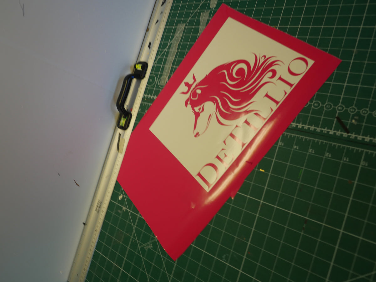 Crowned lion logo — prepared vinyl lettering or artwork, workshop photograph