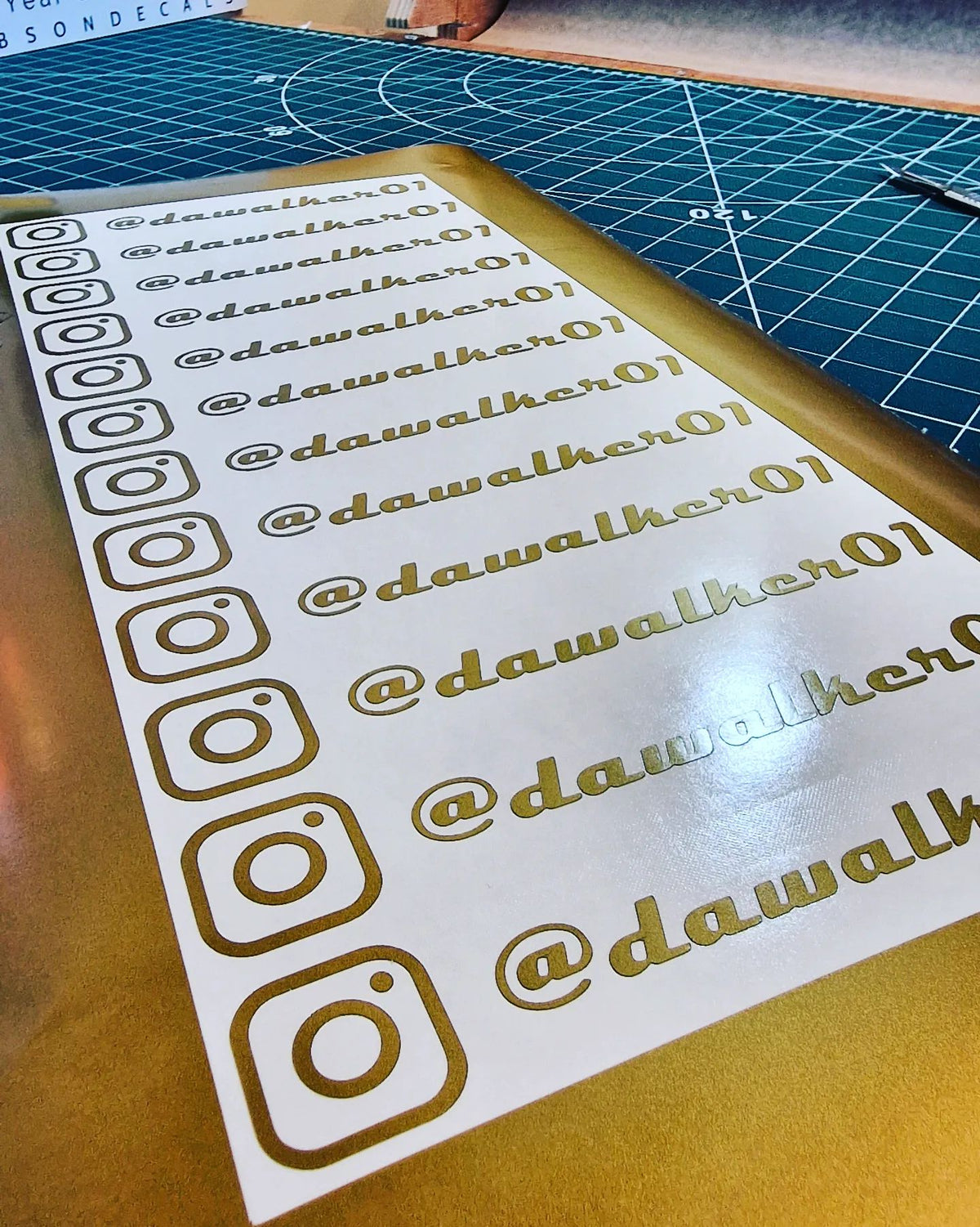 Personalised social media handles — prepared vinyl lettering or artwork, workshop photograph
