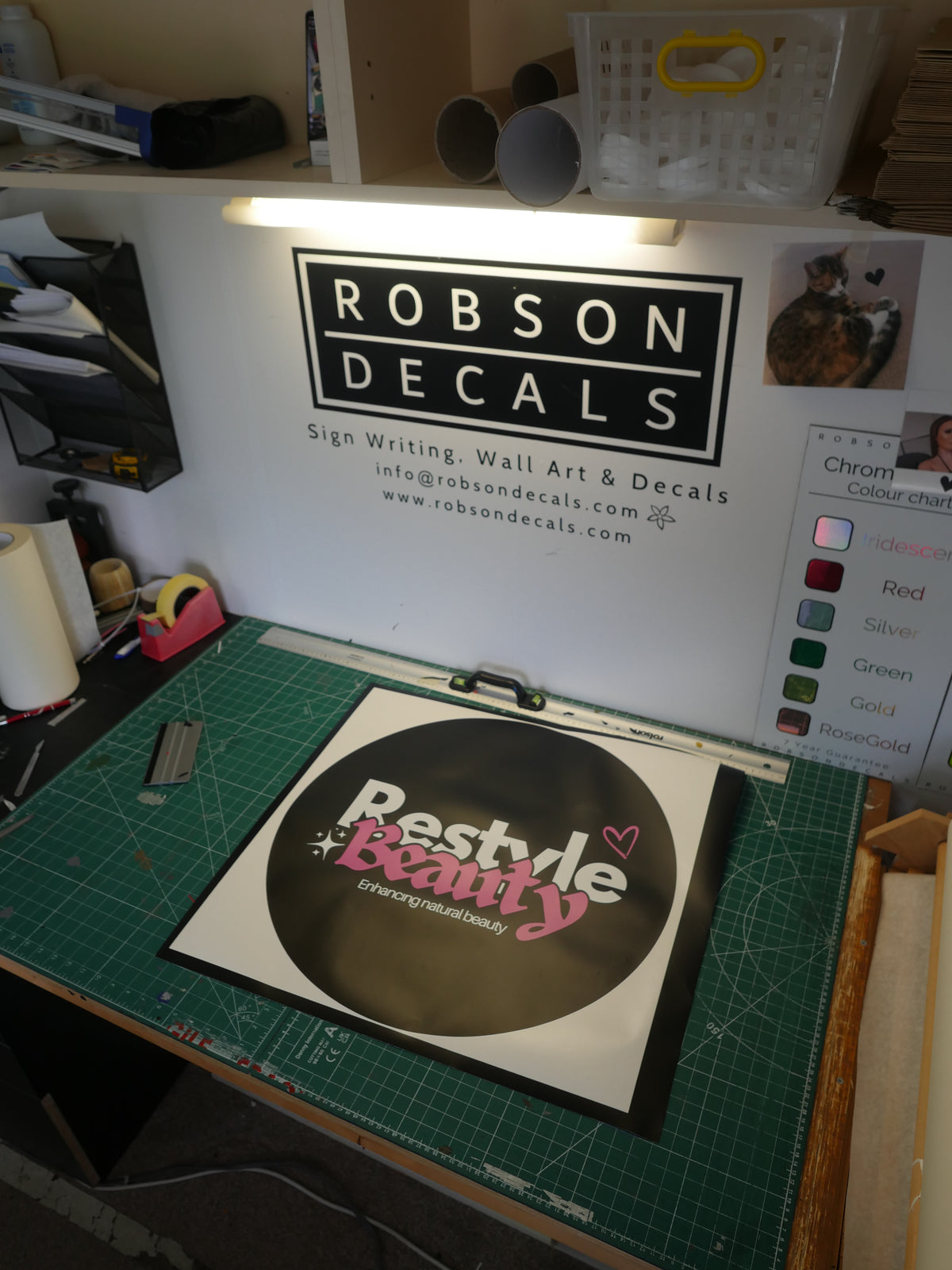 Restyle Beauty logo — prepared vinyl lettering or artwork, workshop photograph