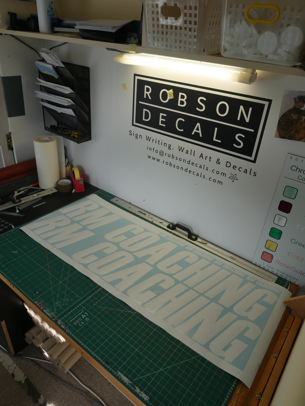 RM Coaching lettering — prepared vinyl lettering or artwork, workshop photograph