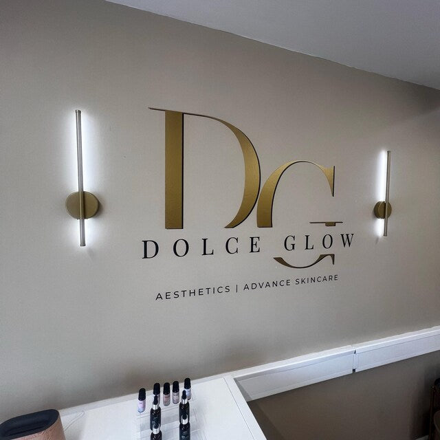 Charlie's Etsy review photograph of Dolce Glow gold logo lettering on a salon wall