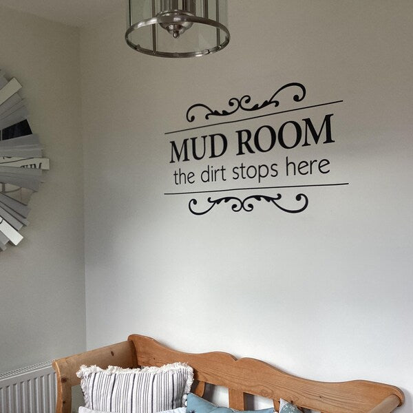 Black Mud Room lettering and decorative flourishes on a white wall.