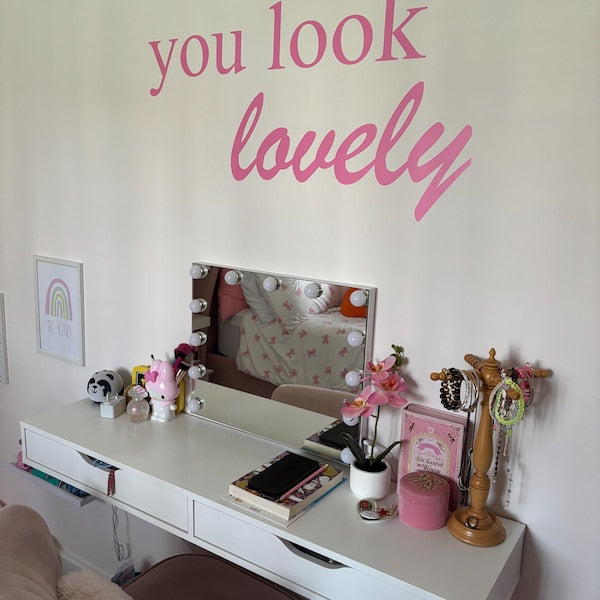 Pink you look lovely lettering above a bedroom dressing table.