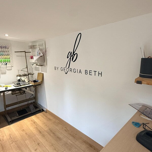Black by Georgia Beth monogram and lettering on a studio wall.