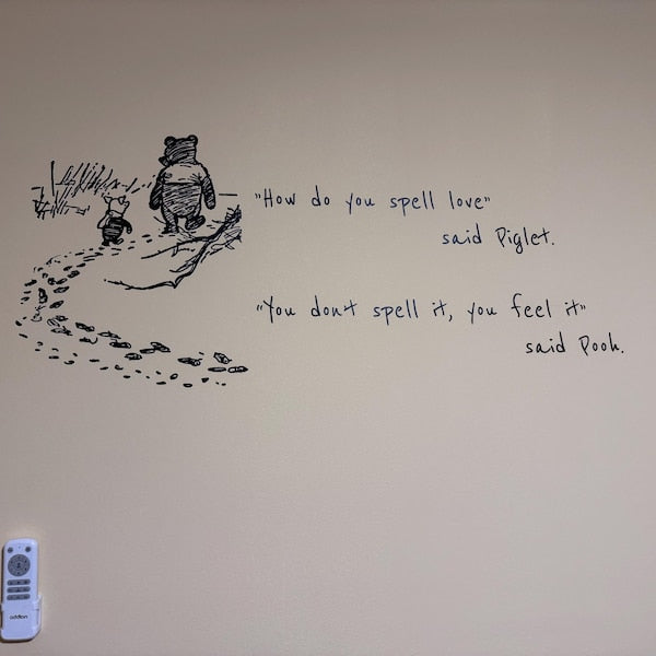 Black illustrated quote decal on a nursery wall.