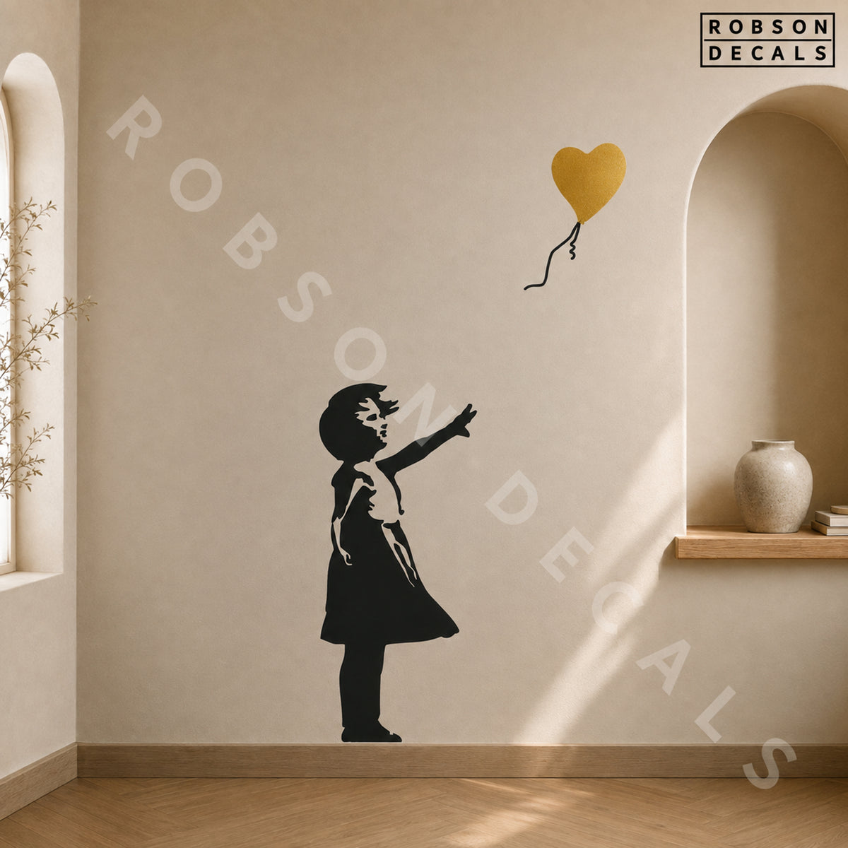 Balloon Girl wall decal with a metallic gold heart balloon on a warm stone-coloured wall, shown as pictured. Robson Decals branding.