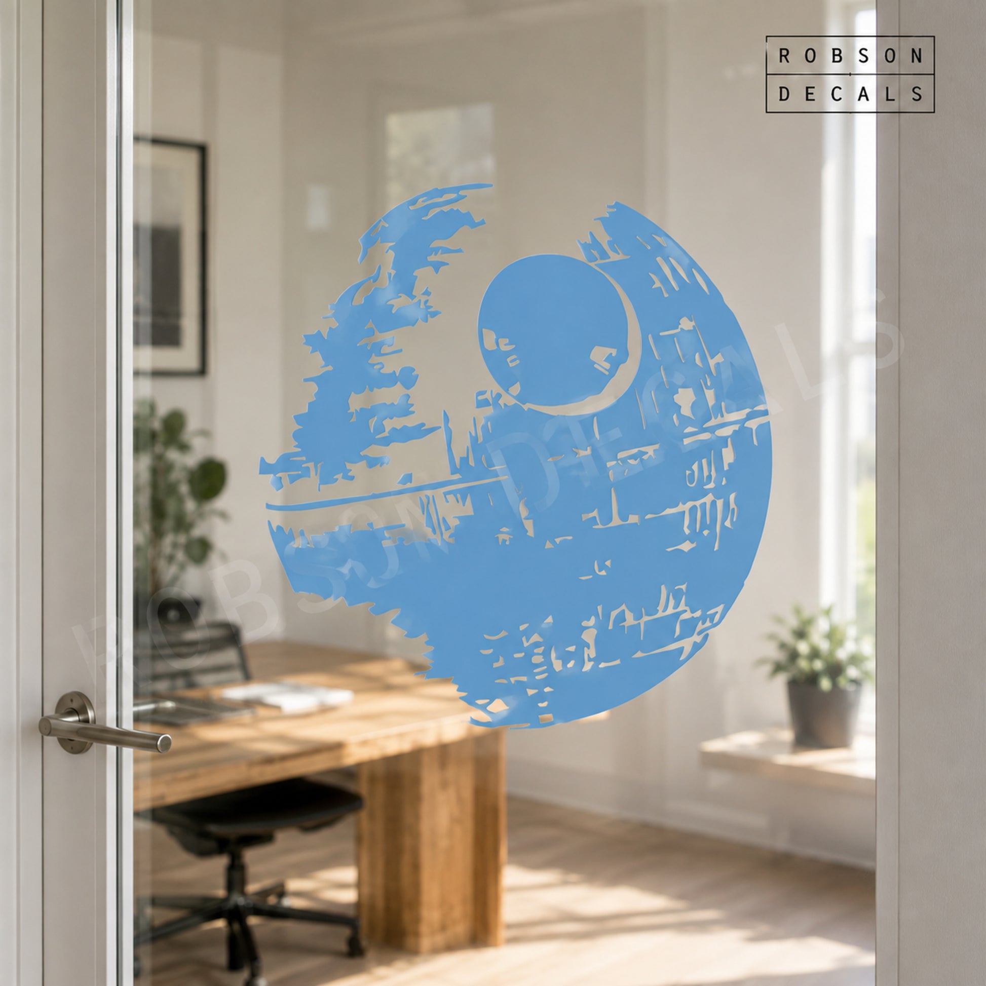Pastel blue Death Star decal on clear glass, reversed or mirrored with the dish on the upper right. Robson Decals watermark.