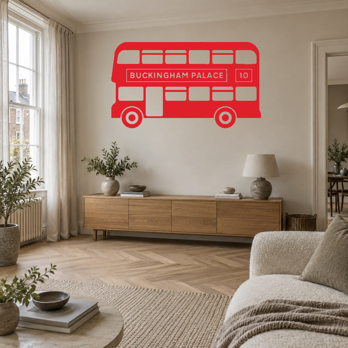 Red single-colour London bus wall decal, including matching wheels, in a living room. Buckingham Palace route 10.