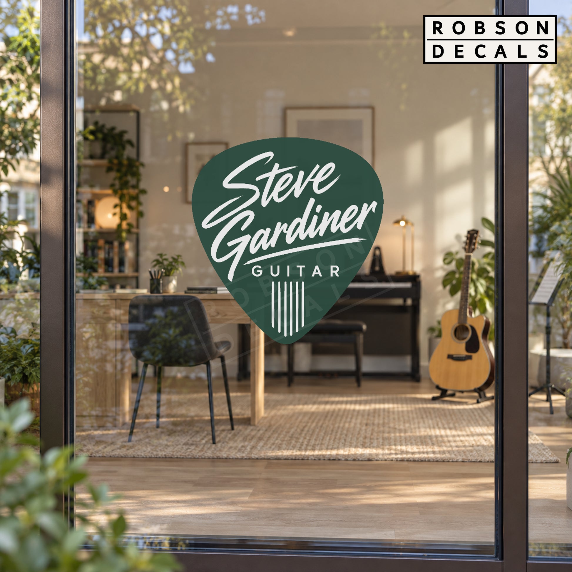 Forest green guitar pick decal with white lettering on a music studio glass door