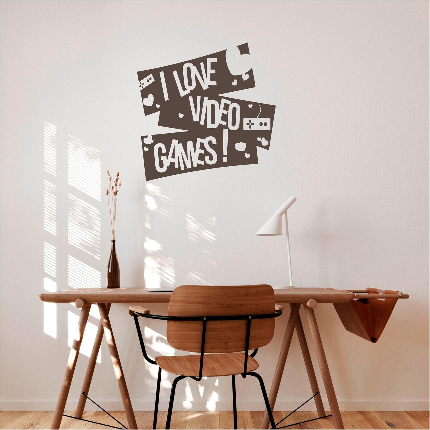 Dark brown I Love Video Games wall decal with controllers and hearts above a wooden desk.