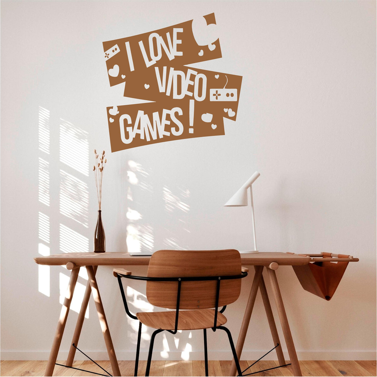Brown I Love Video Games wall decal with controllers and hearts above a wooden desk.