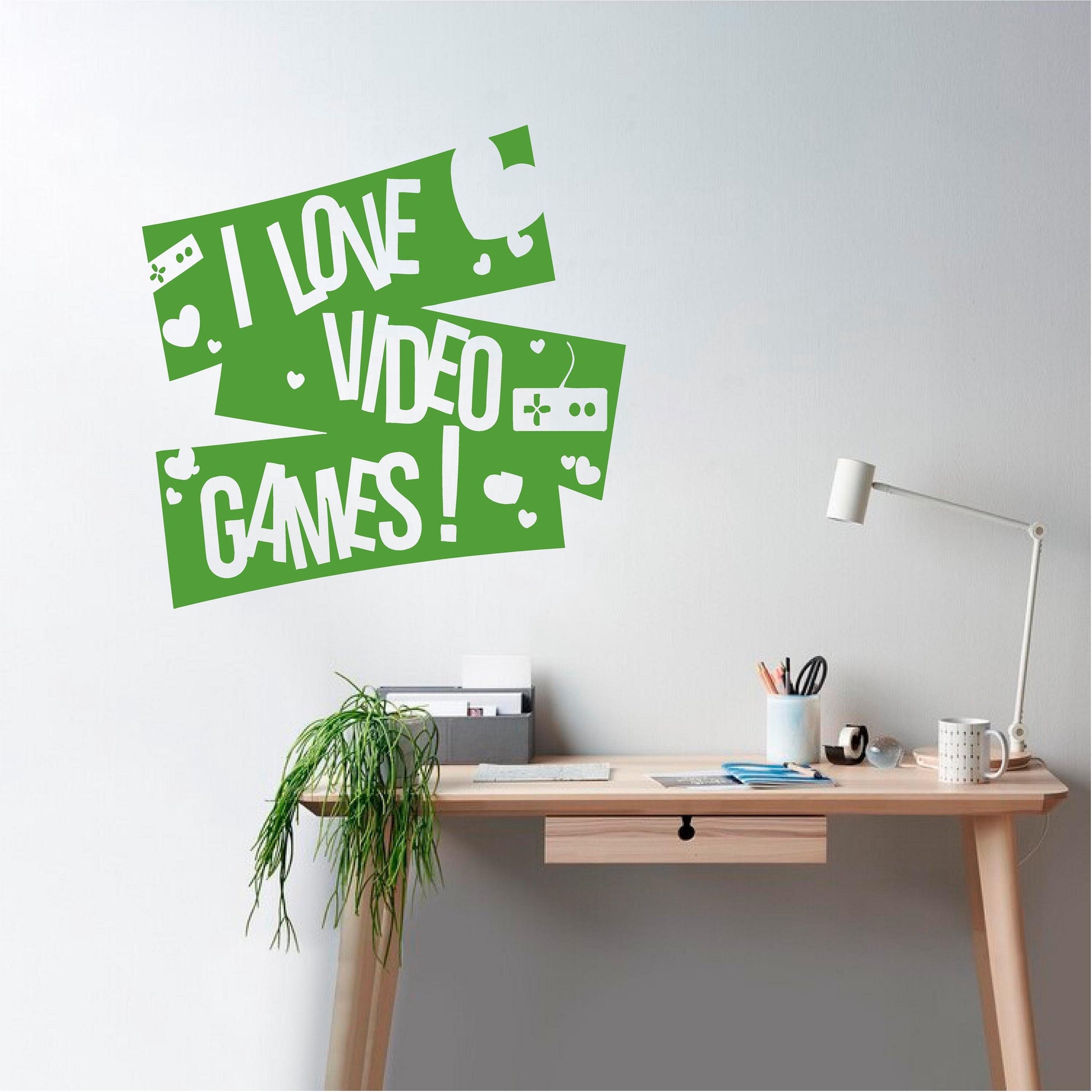 Bright green I Love Video Games wall decal with controllers and hearts above a study desk.