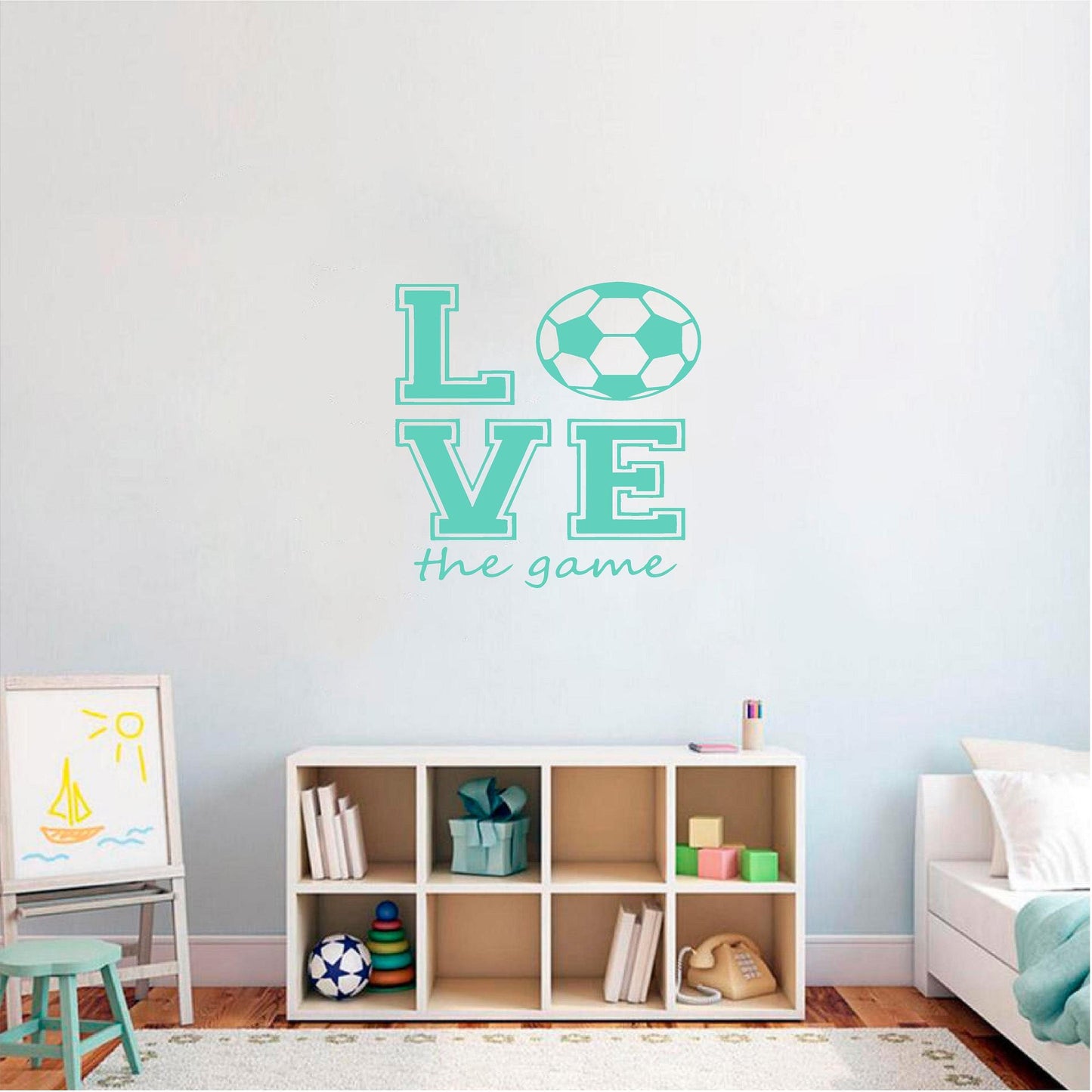 Mint Love the Game football wall decal above a cube shelf in a child's room.