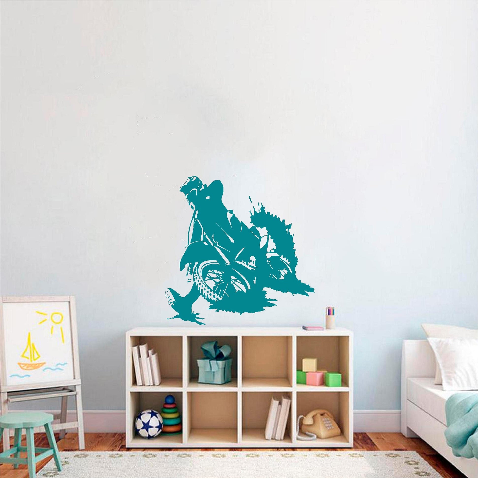 Teal motocross rally rider wall decal above a cube shelf