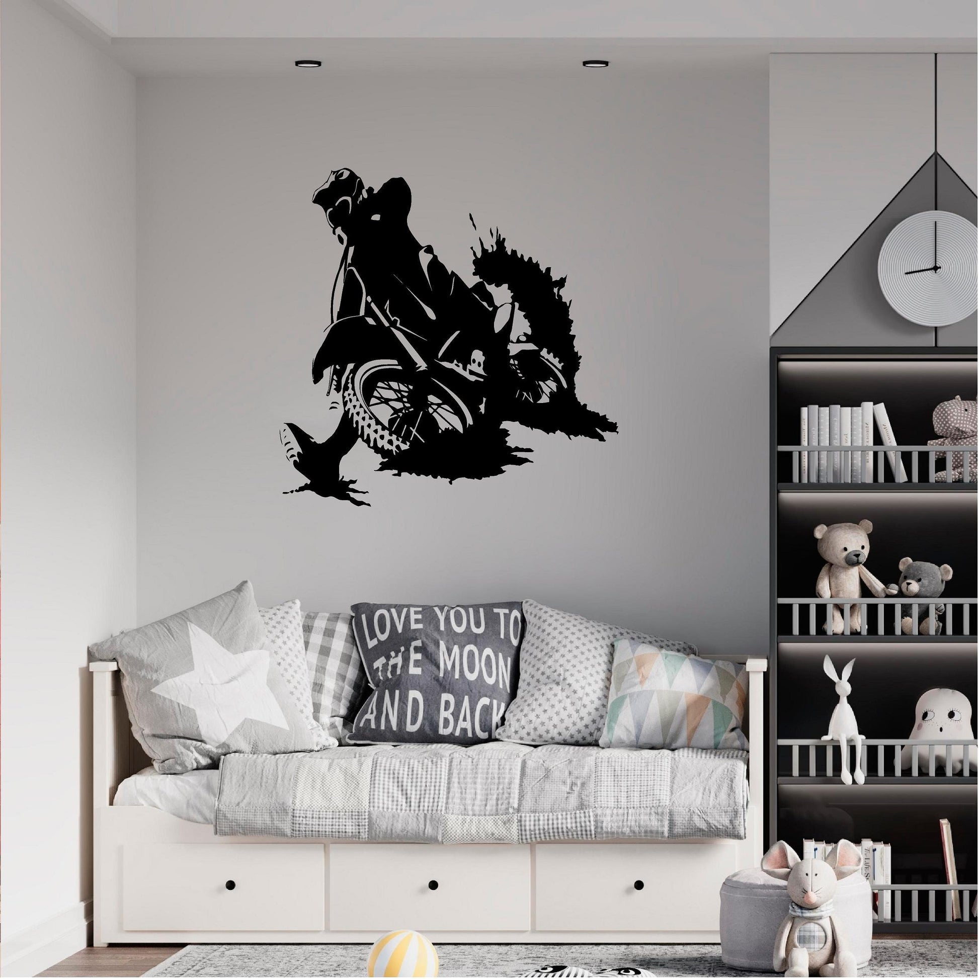 Black motocross rally rider wall decal above a child's daybed