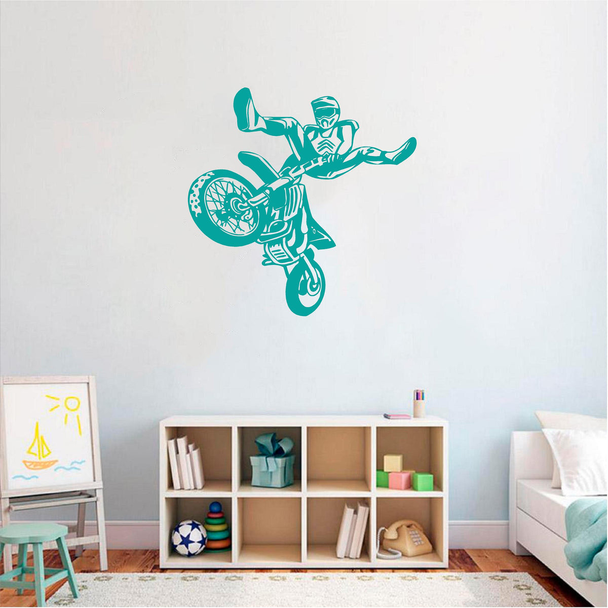 Teal freestyle motocross rider wall decal above a cube shelf