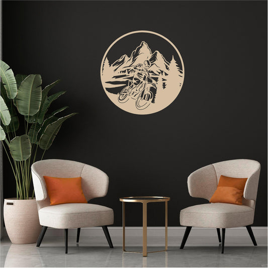 Cream circular mountain biker wall decal with mountains and pine trees on a black wall above two chairs.