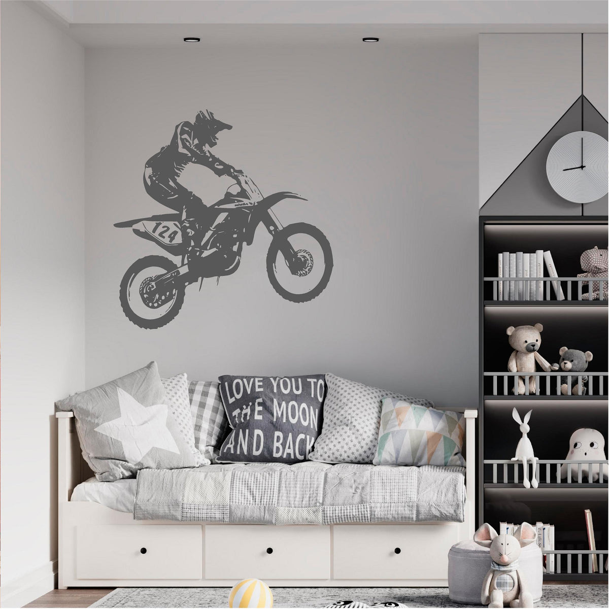 Grey motocross rider wall decal above a grey daybed