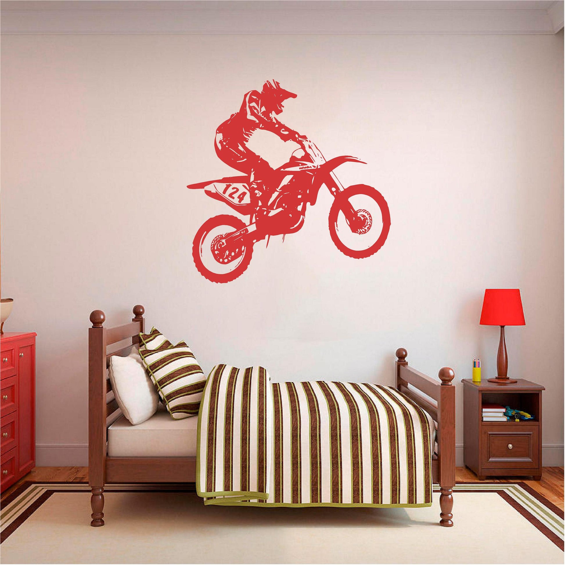 Red motocross rider wall decal above a wooden bed