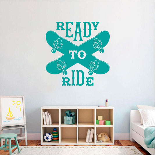 Teal Ready to Ride wall decal with two crossed skateboards above a cube shelf in a child's room.