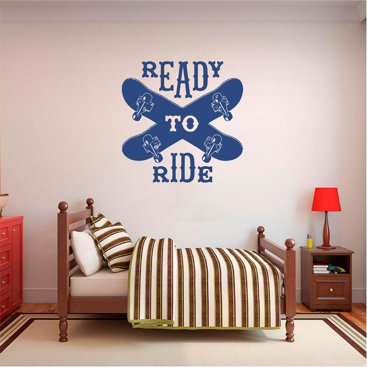 Navy blue Ready to Ride wall decal with two crossed skateboards above a wooden single bed.