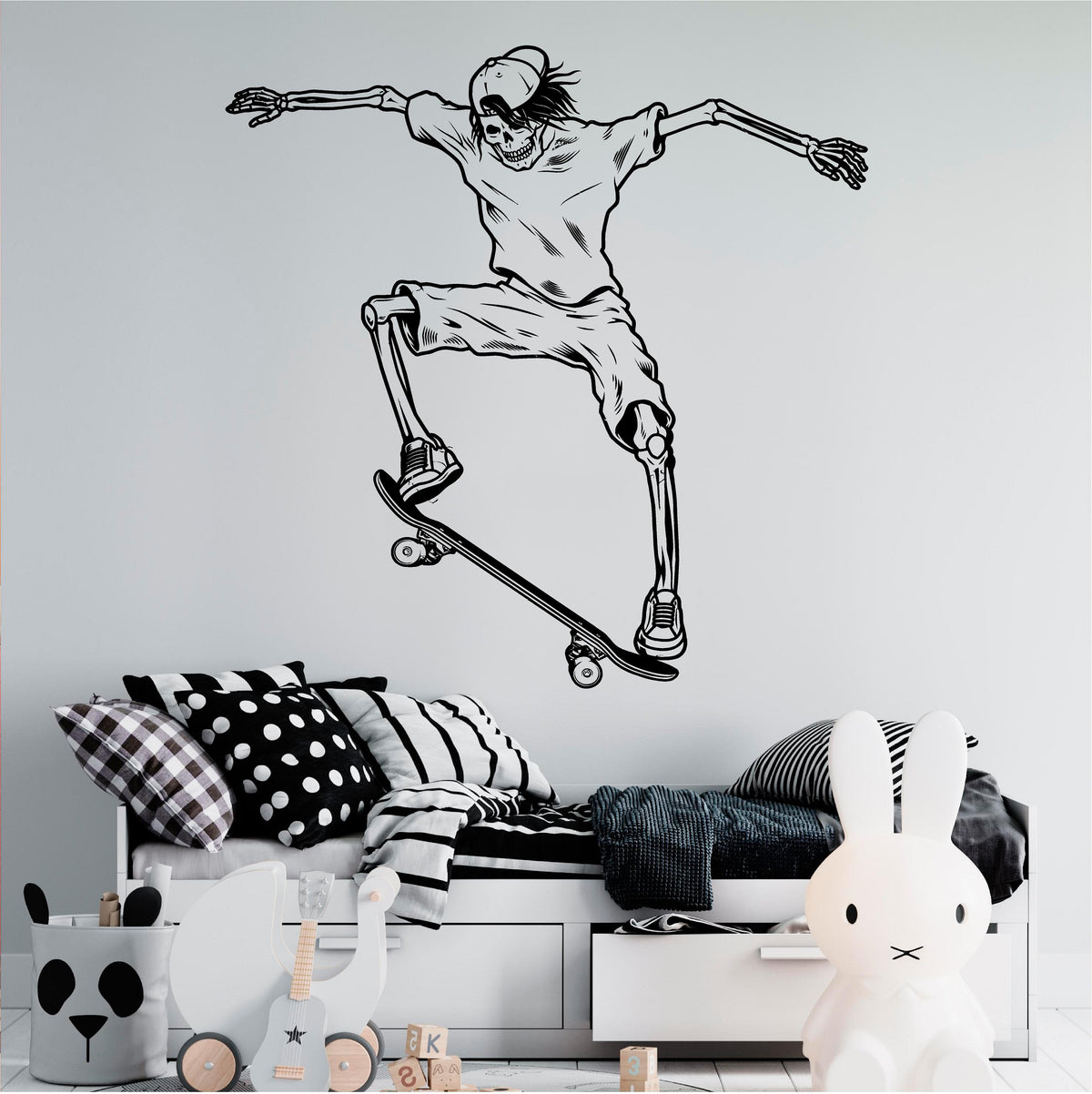 Black skeleton skateboarder wall decal with a backwards cap, shorts and trainers above a child's bed.