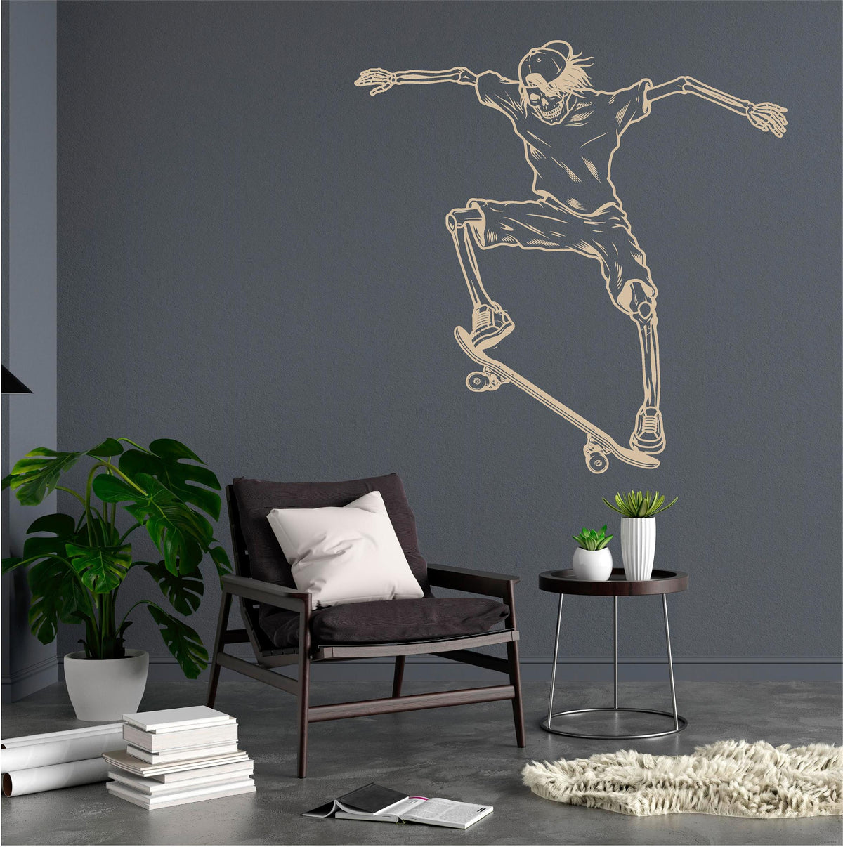 Cream skeleton skateboarder wall decal on a blue-grey wall above a black chair and plants.