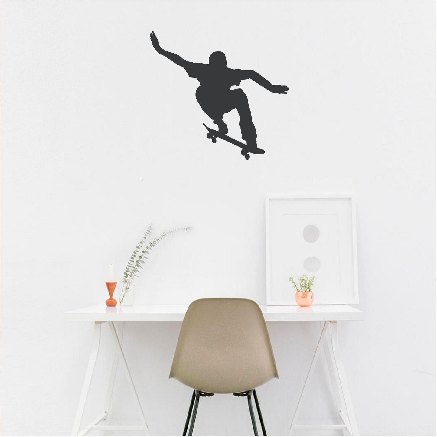 Black ollie skateboarder wall decal above a white desk