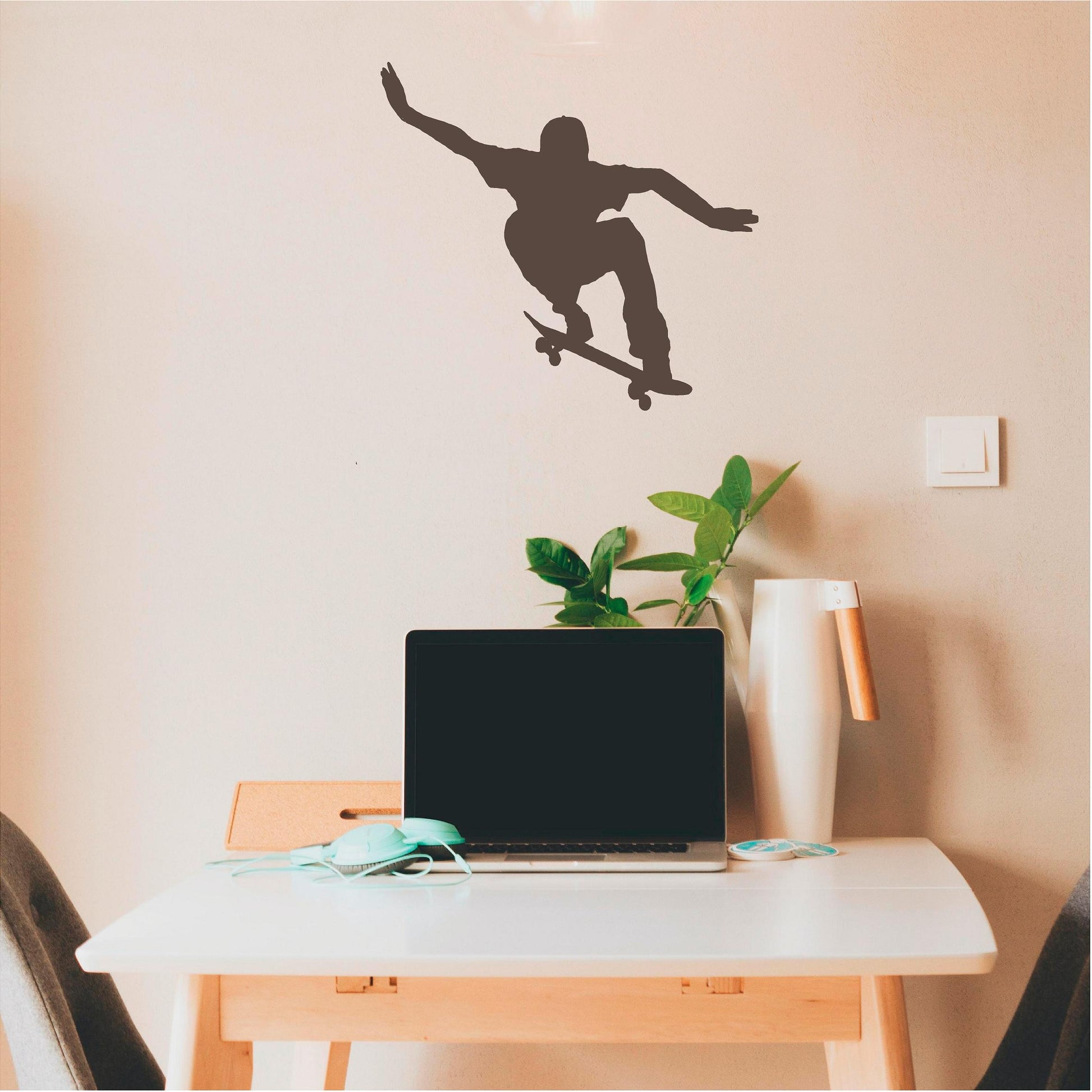 Brown ollie skateboarder wall decal above a laptop desk