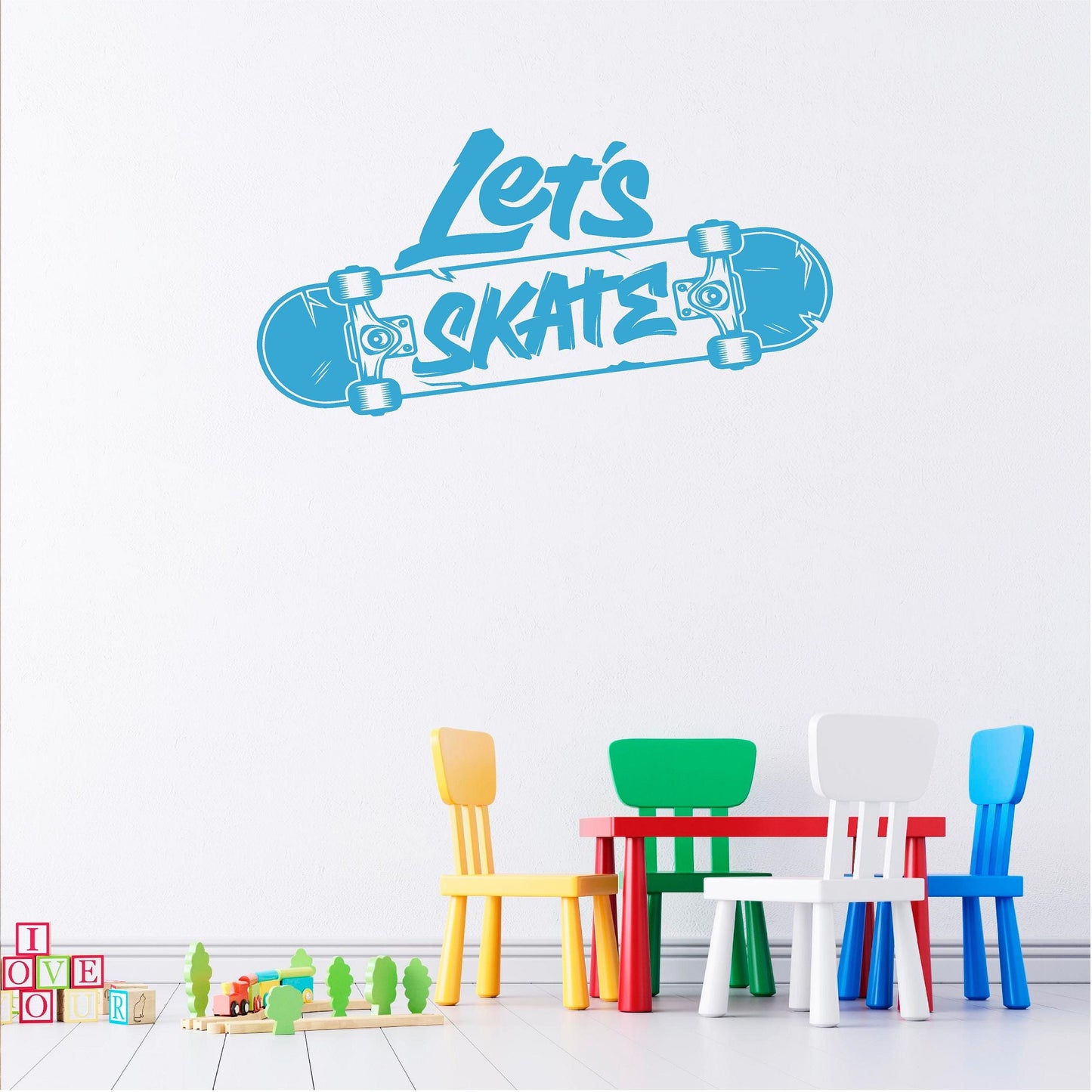 Blue Let's Skate skateboard wall decal above colourful children's chairs