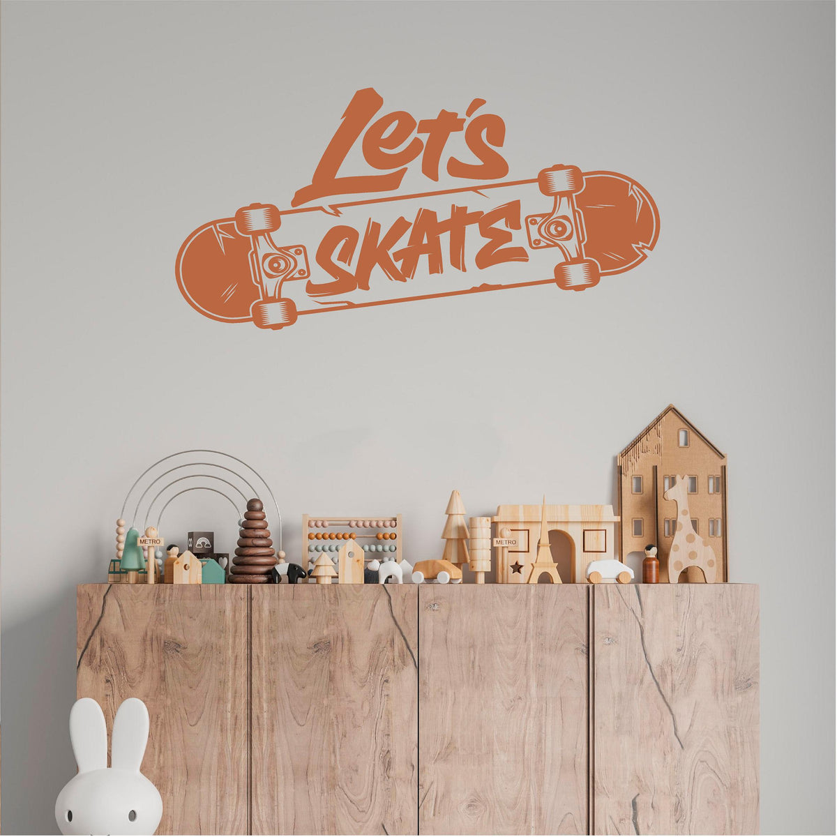 Orange Let's Skate wall decal above a toy cupboard