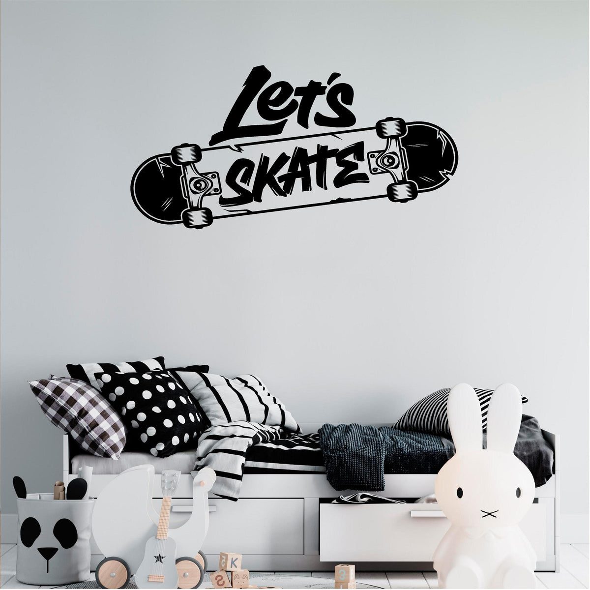 Black Let's Skate wall decal above a child's bed