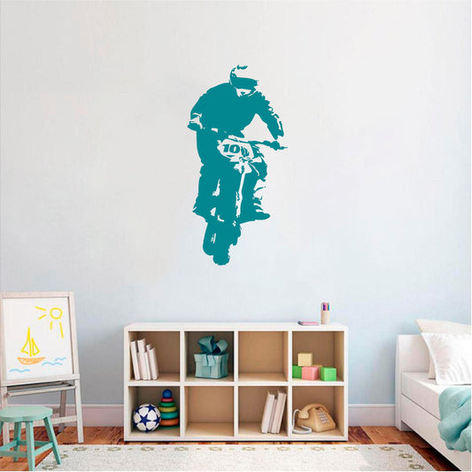 Teal rally biker wall decal above a bedroom storage unit