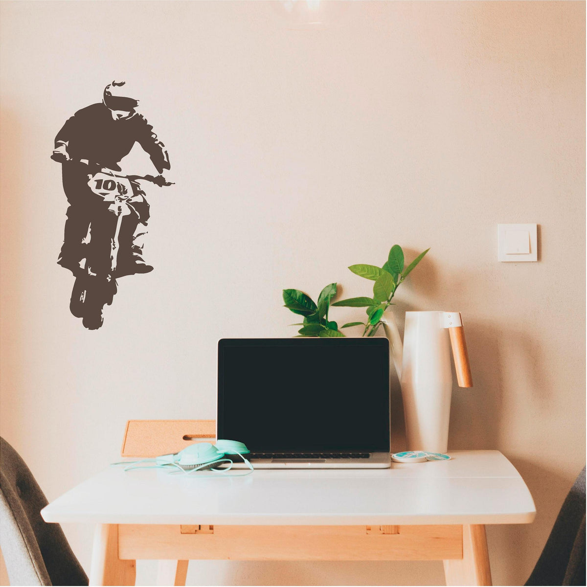 Brown rally biker wall decal beside a laptop desk