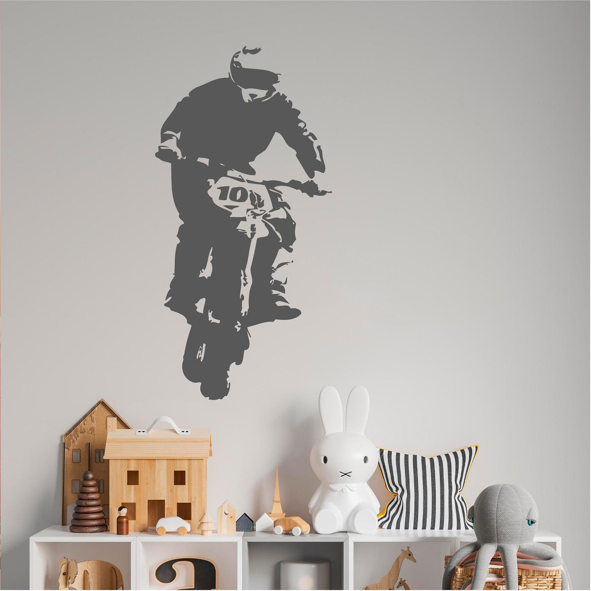 Grey rally biker wall decal above a toy storage unit