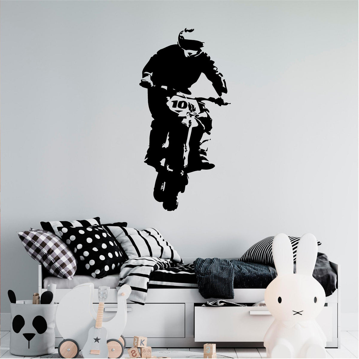 Black rally biker wall decal above a child's bed