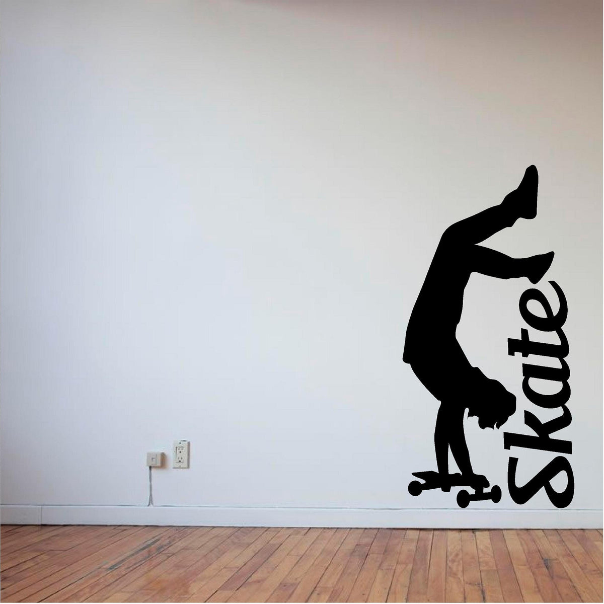 Black handstand skater wall decal on a pale wall