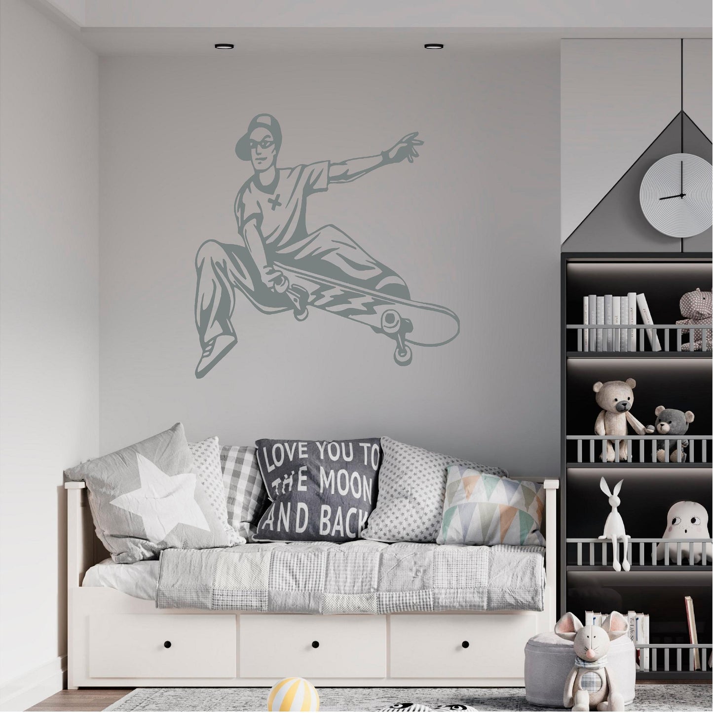 Grey skateboarder trick wall decal above a daybed