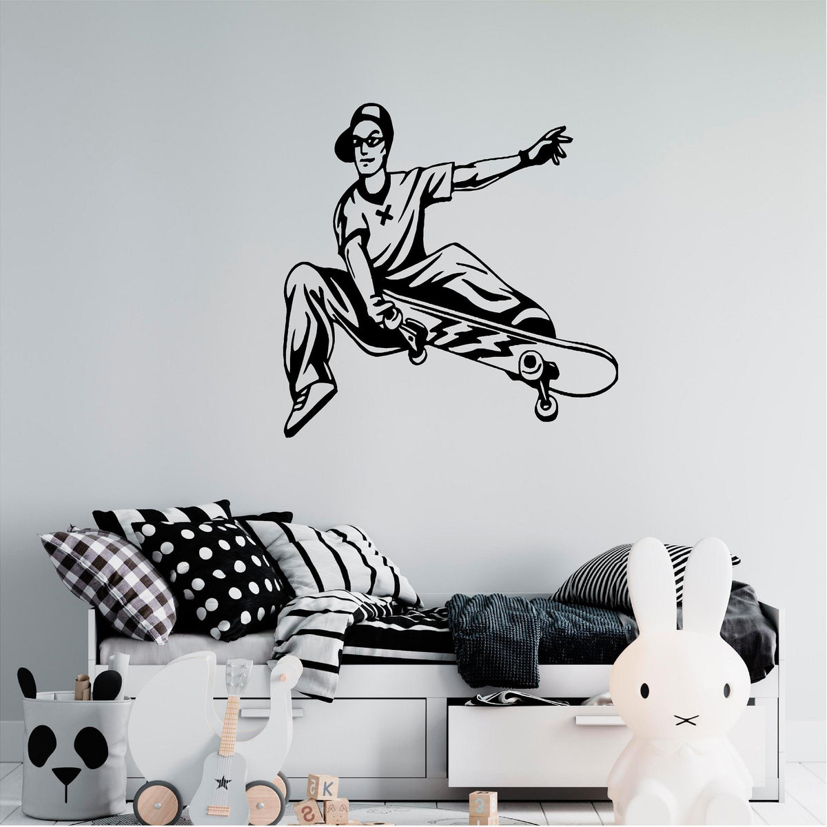 Black skateboarder trick wall decal above a child's bed