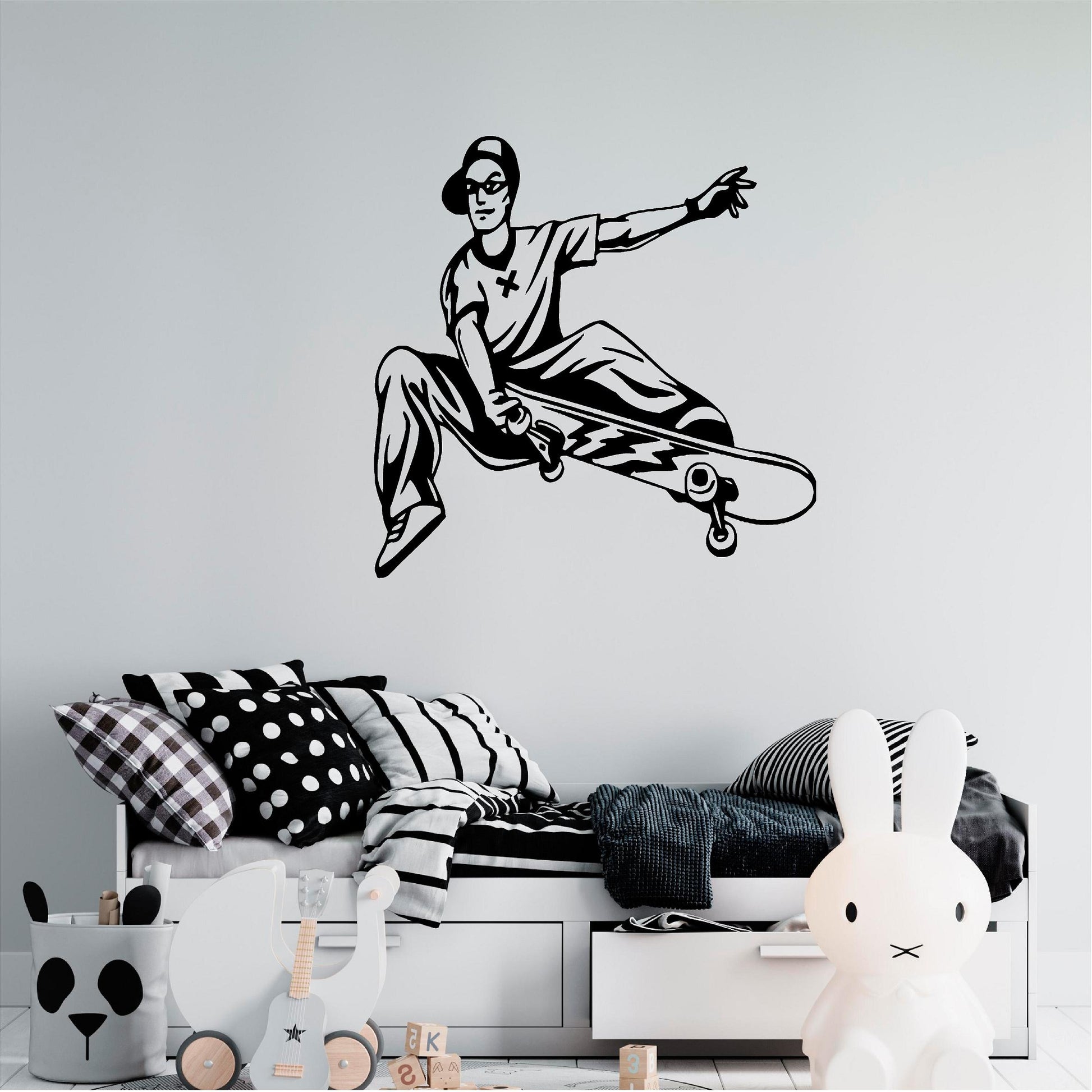 Black skateboarder trick wall decal above a child's bed