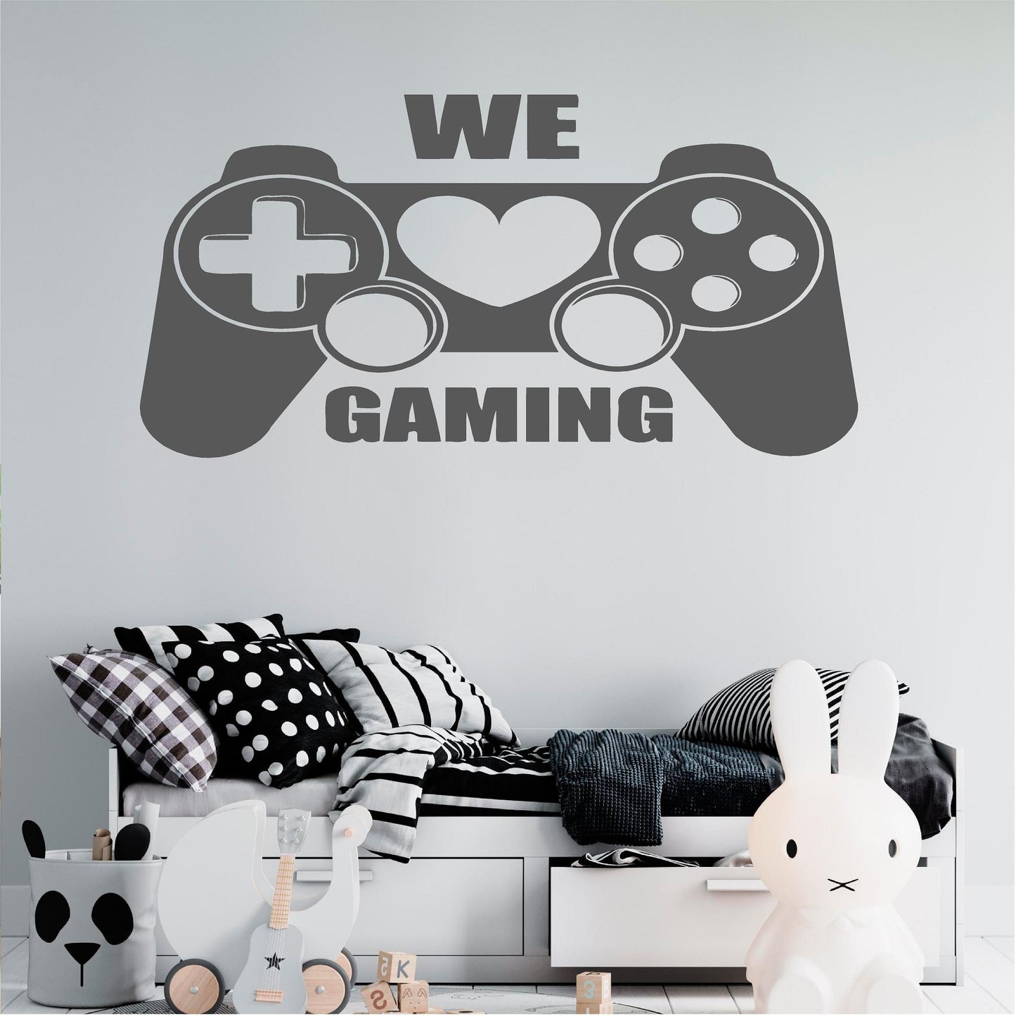 Grey We Love Gaming controller wall decal above a child's bed