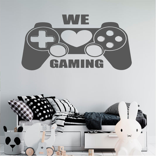 Grey We Love Gaming controller wall decal above a child's bed