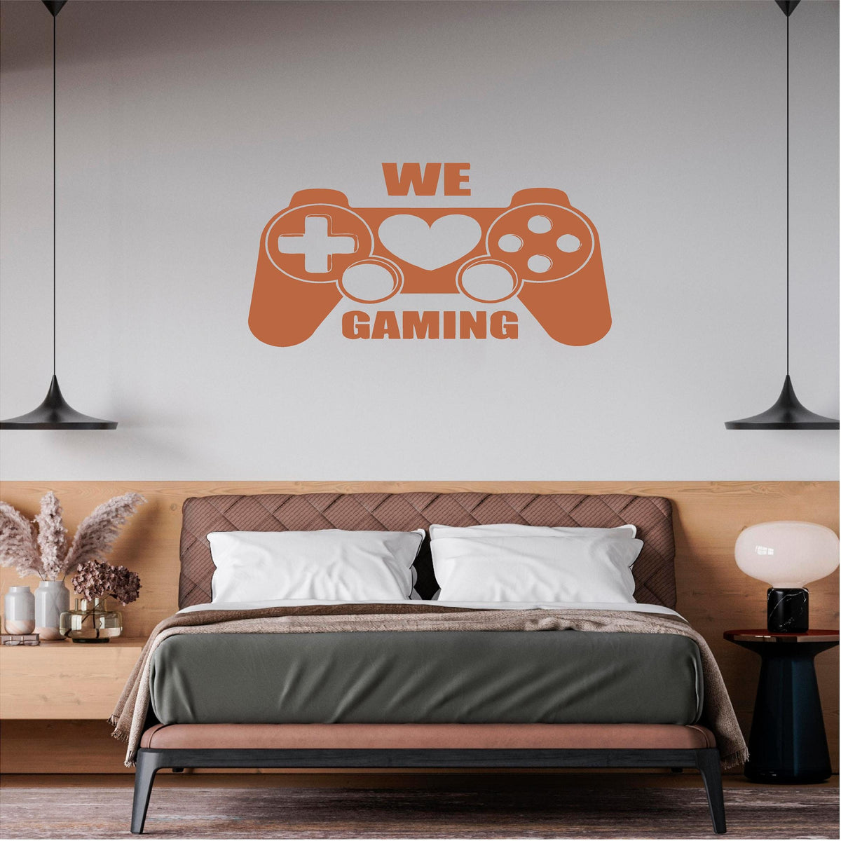 Orange We Love Gaming controller wall decal above a double bed