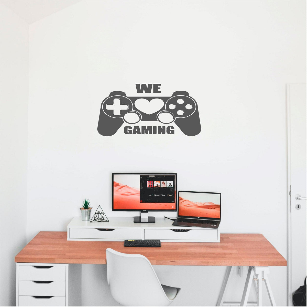 Grey We Love Gaming controller wall decal above a computer desk