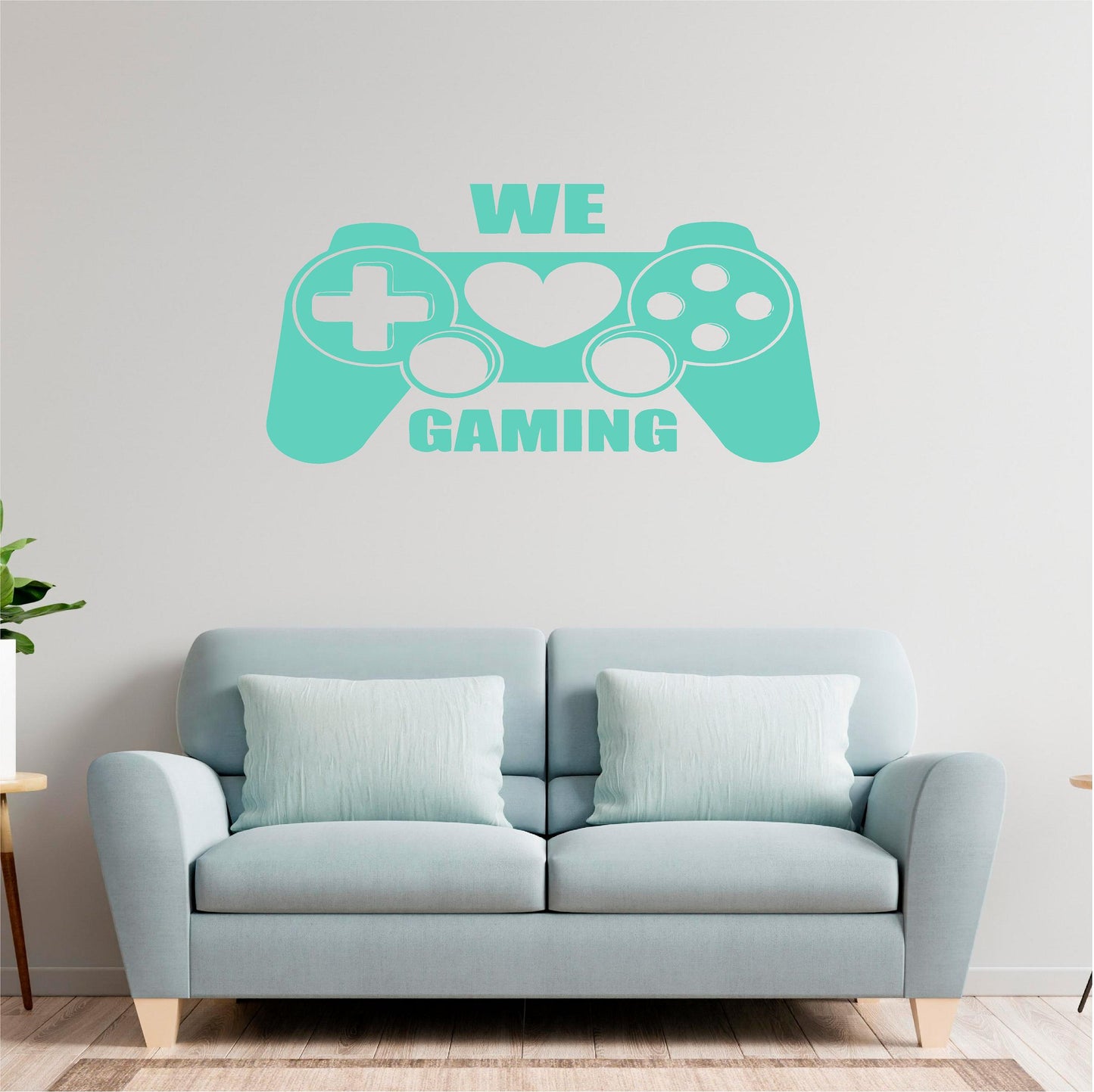 Turquoise We Love Gaming controller wall decal above a pale blue sofa