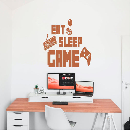 Copper-coloured Eat Sleep Game wall decal above a computer desk