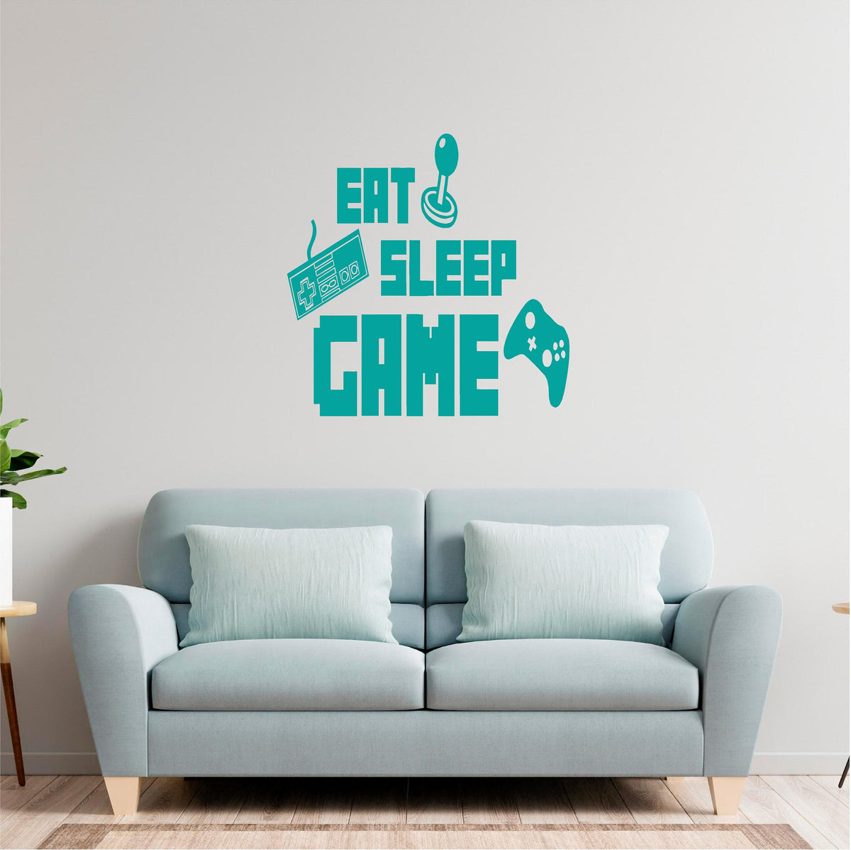 Turquoise Eat Sleep Game wall decal above a pale sofa