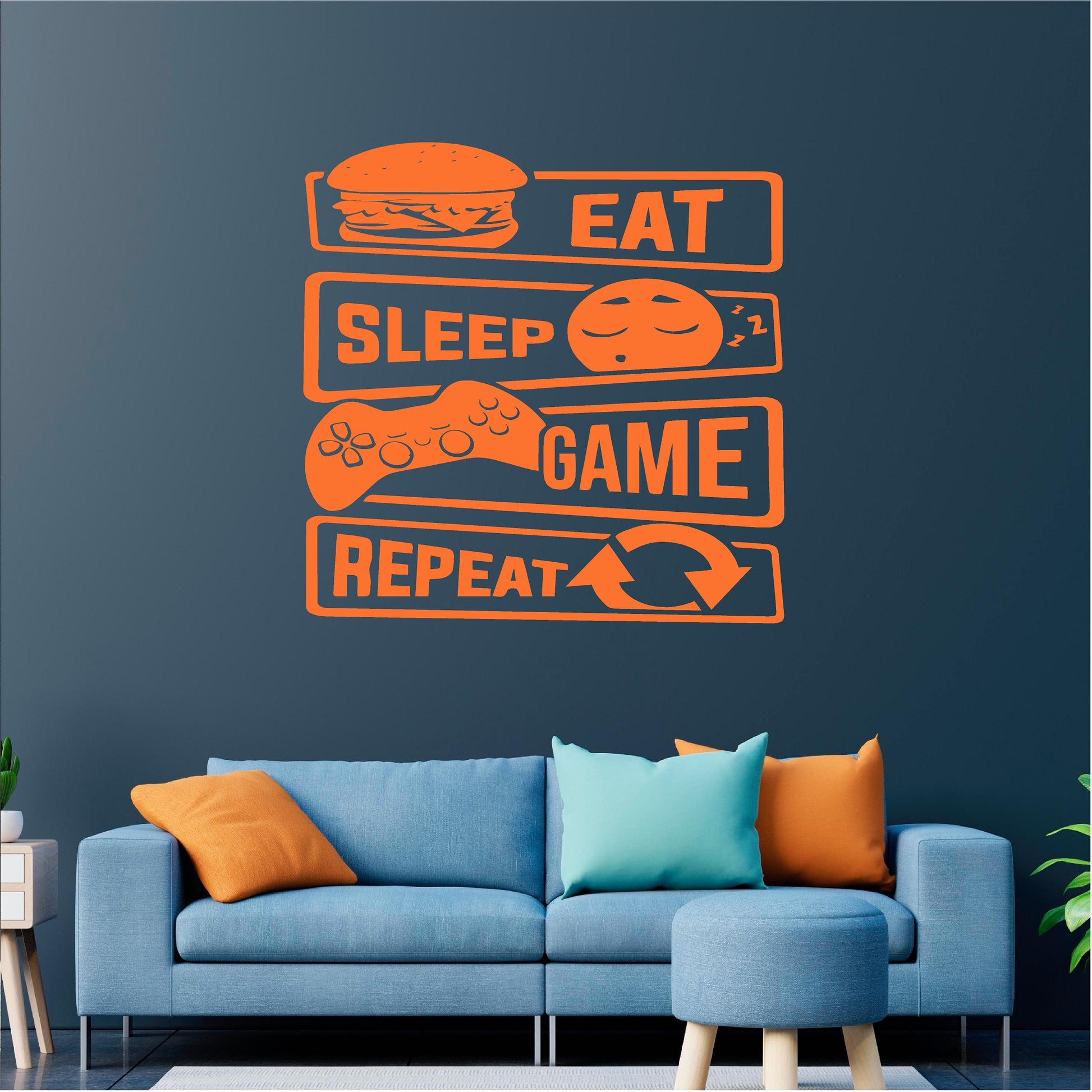 Orange Eat Sleep Game Repeat wall decal above a blue sofa